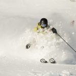 Skier in chest deep powder.